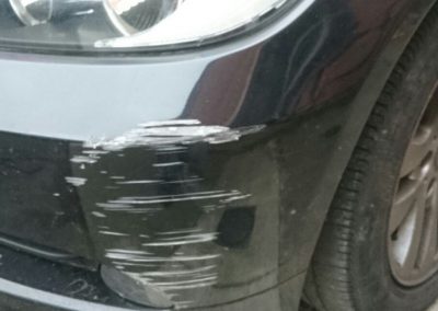 Image of a BMW car with a bumper scuff